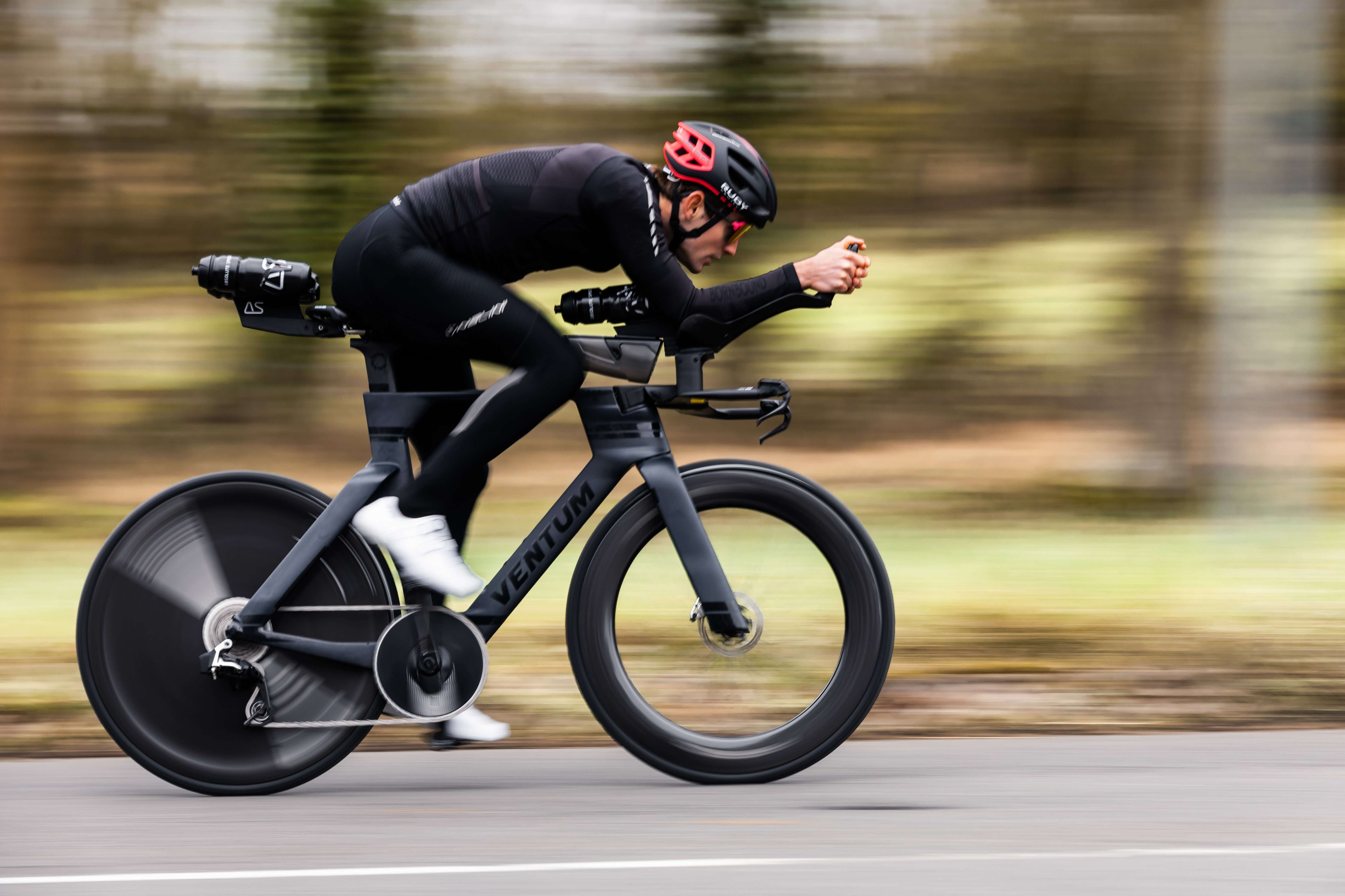 Kieran Lindars riding a high-speed bike showcasing the Absolute Speed Behind Saddle Hydration product in action.